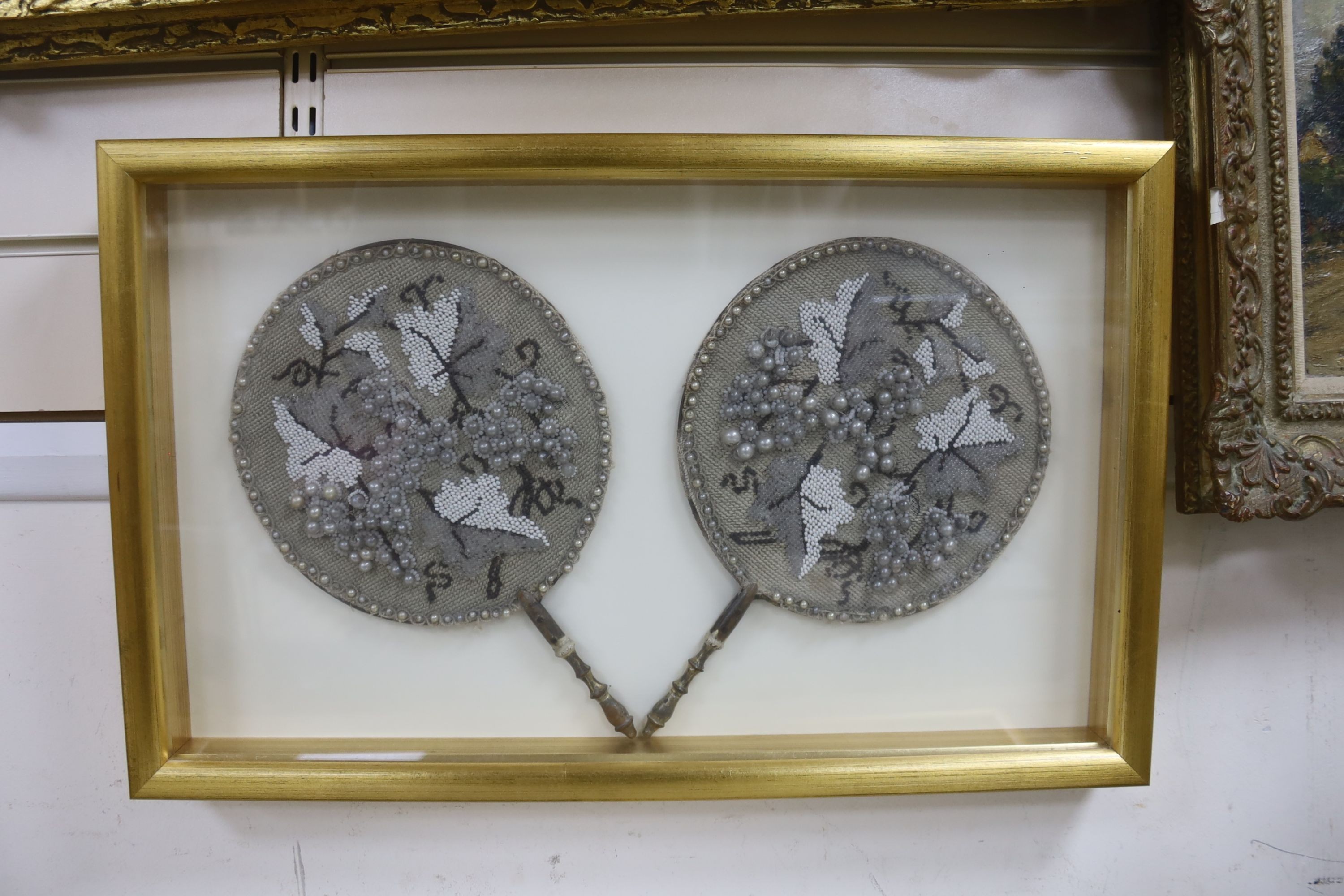 An ostrich feather fan, case 45 x 75.5 cm and a pair of cased 19th century bead worked face screens